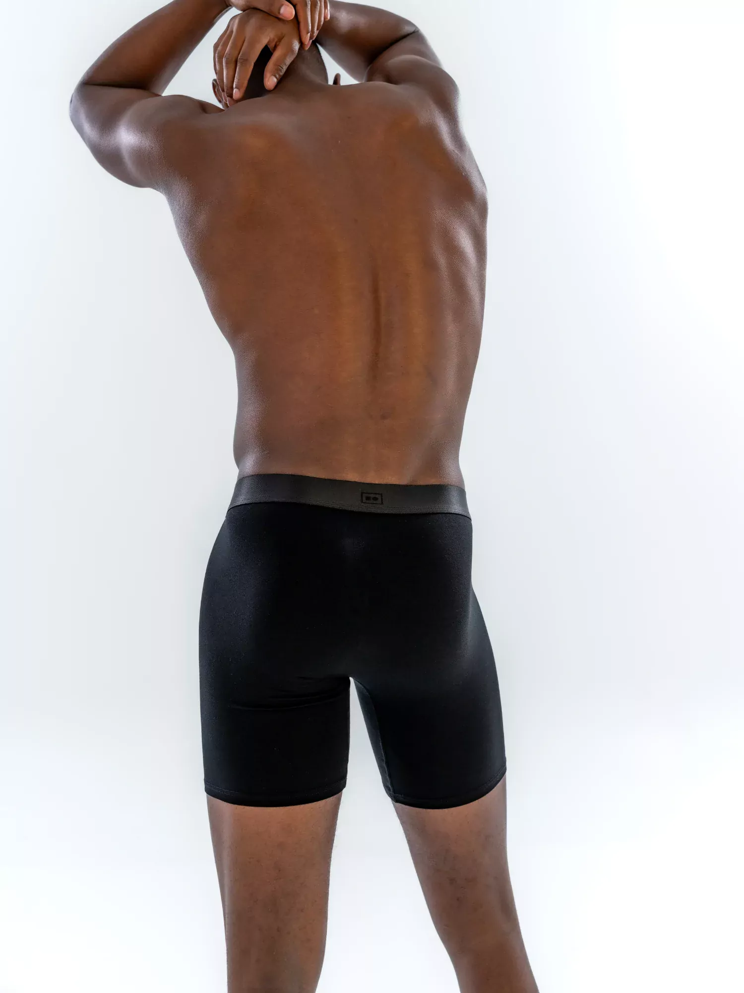 Model wearing the 6" Tonal Boxer Brief in black, back view