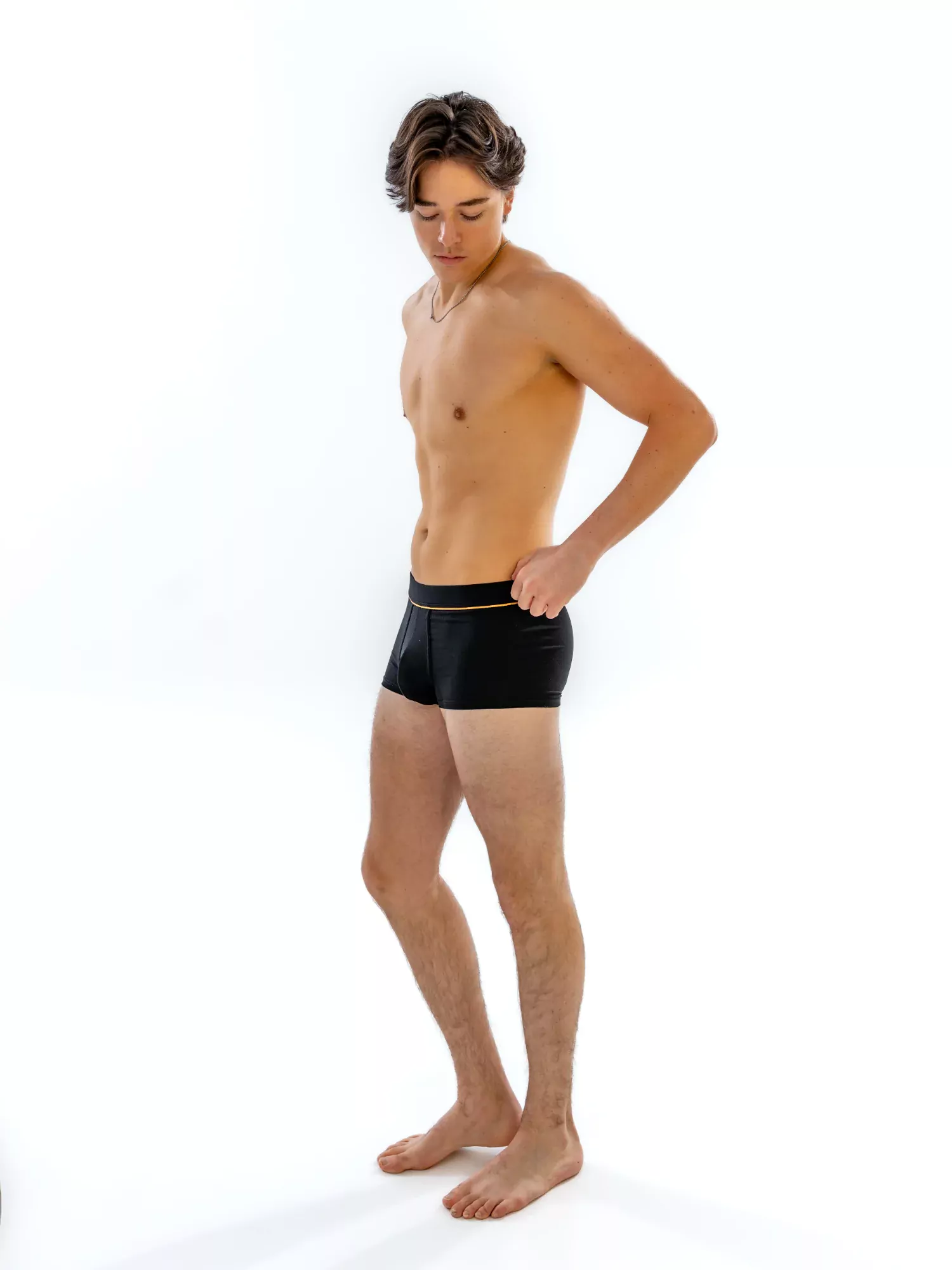 Model wearing the 1" Fabric-Wrapped Trunk in black, side view