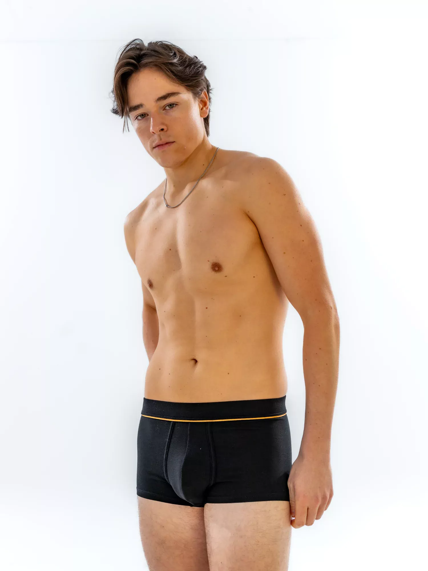 Model wearing the 1" Fabric-Wrapped Trunk in black, three-quarter front view