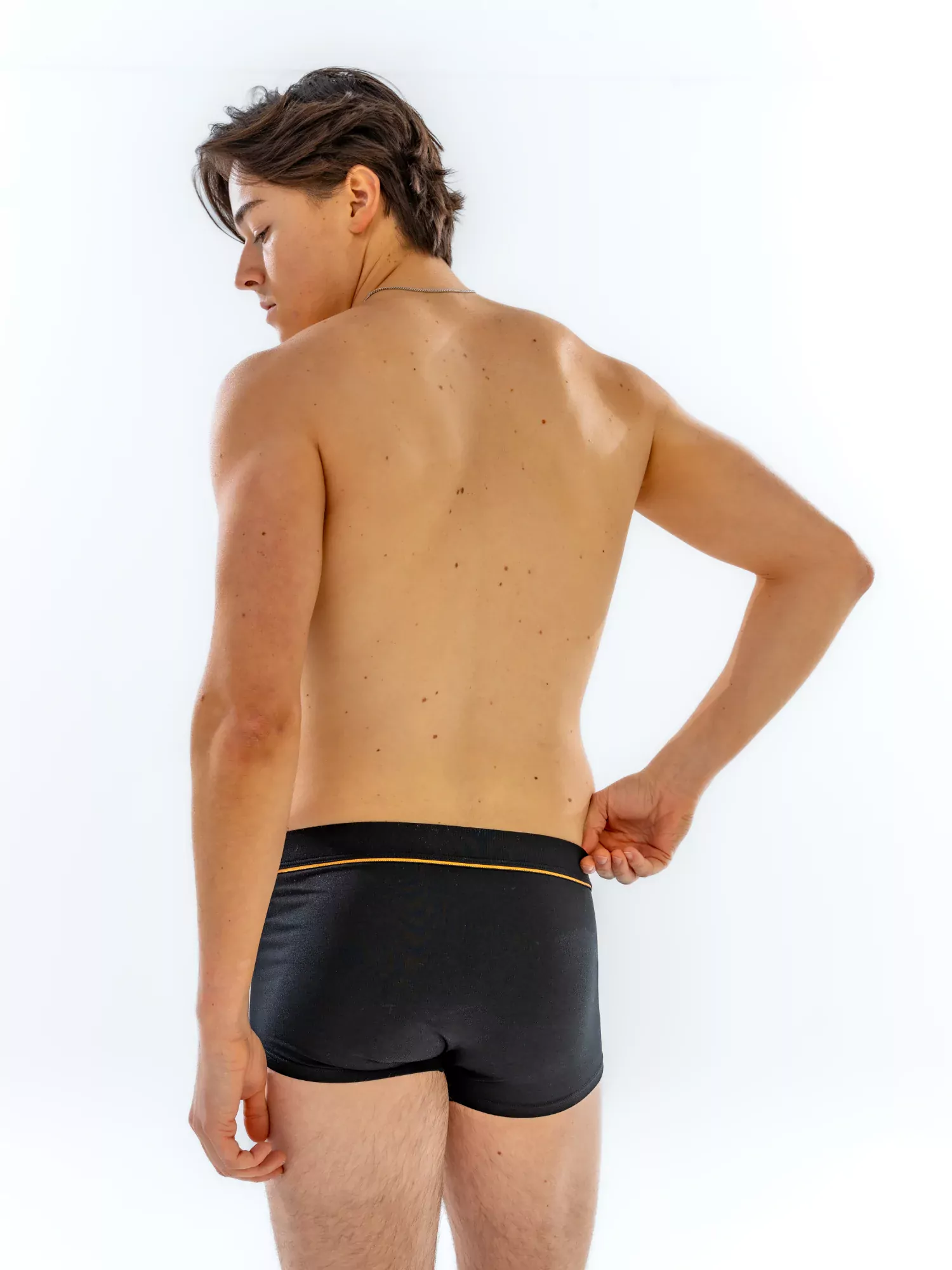 Model wearing the 1" Fabric-Wrapped Trunk in black, three-quarter back view