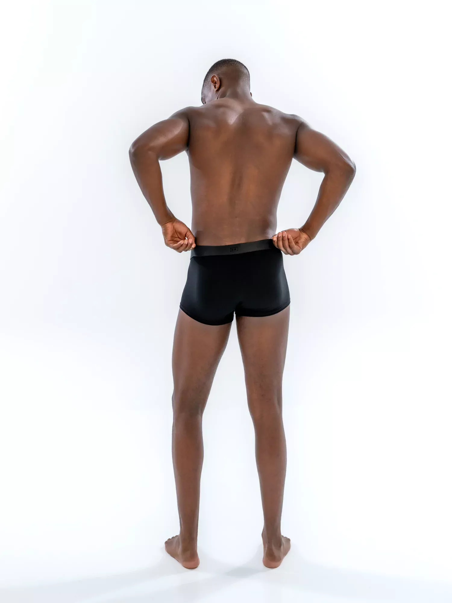 Model wearing the 1" Tonal Trunk in black, back view