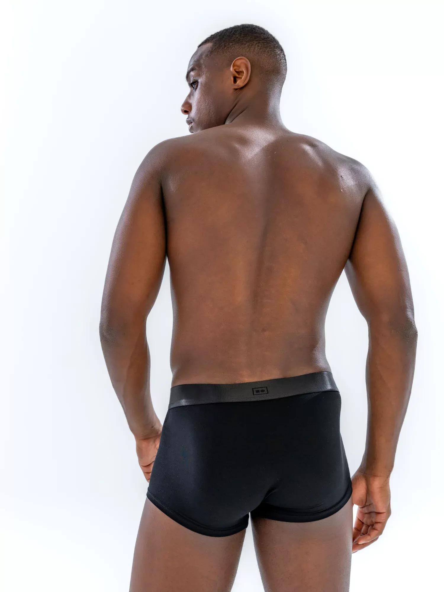 Model wearing the 1" Tonal Trunk in black, back view