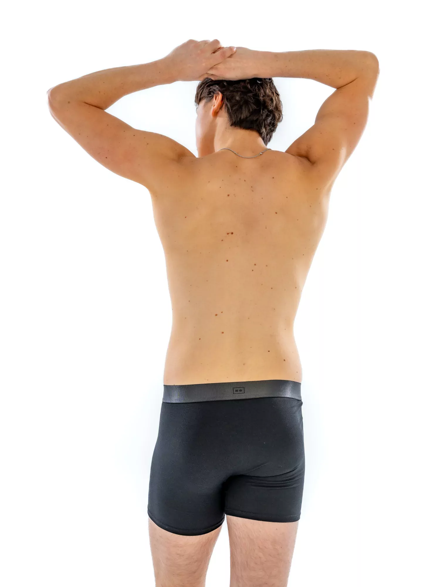 Model wearing the 4" Tonal Boxer Brief in black, back view
