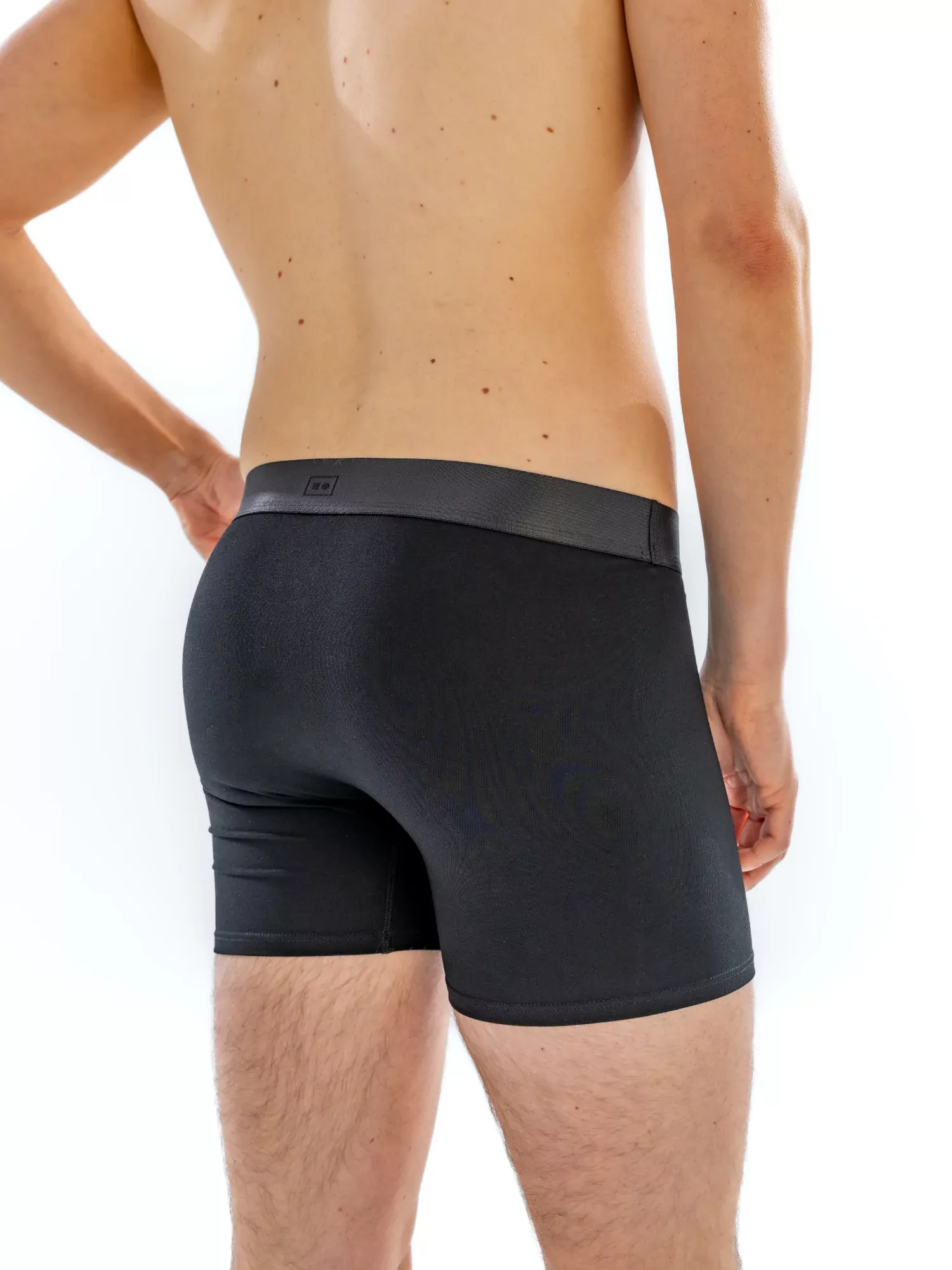 Close-up of the 4" Tonal Boxer Brief in black on a model, back view