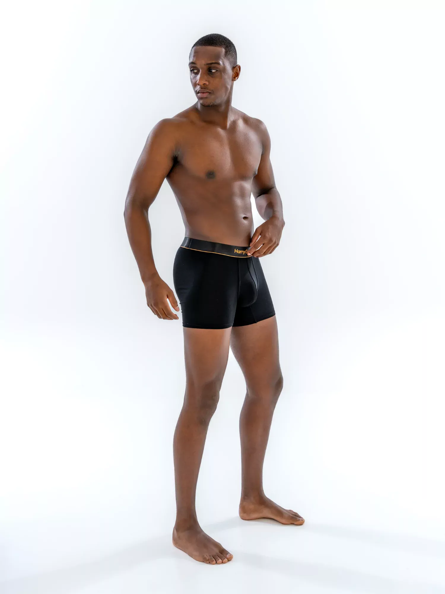 Model wearing the 4" Classic Boxer Brief in black, three-quarter view