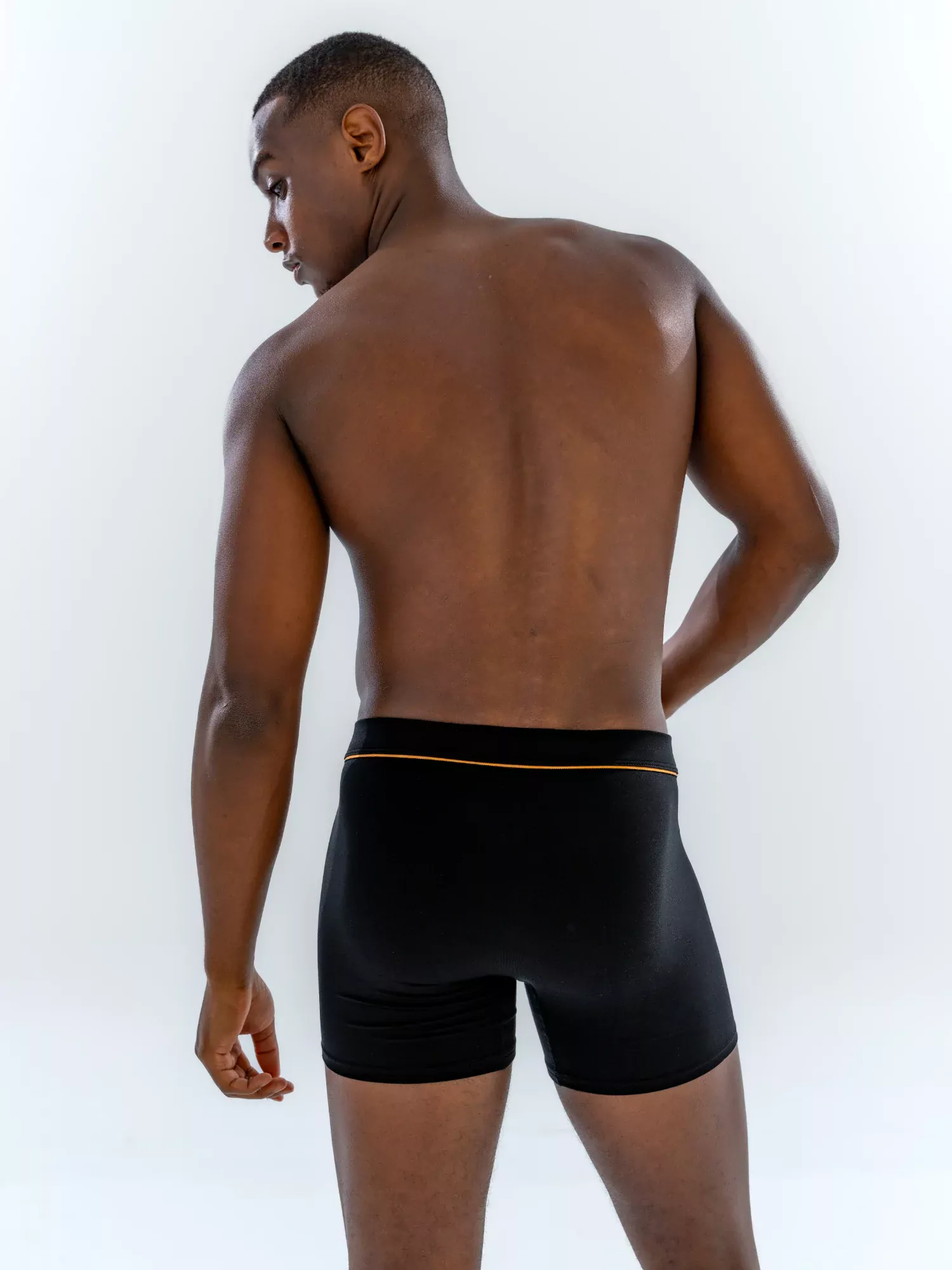 Model wearing the 4" Fabric-Wrapped Boxer Brief in black, back view