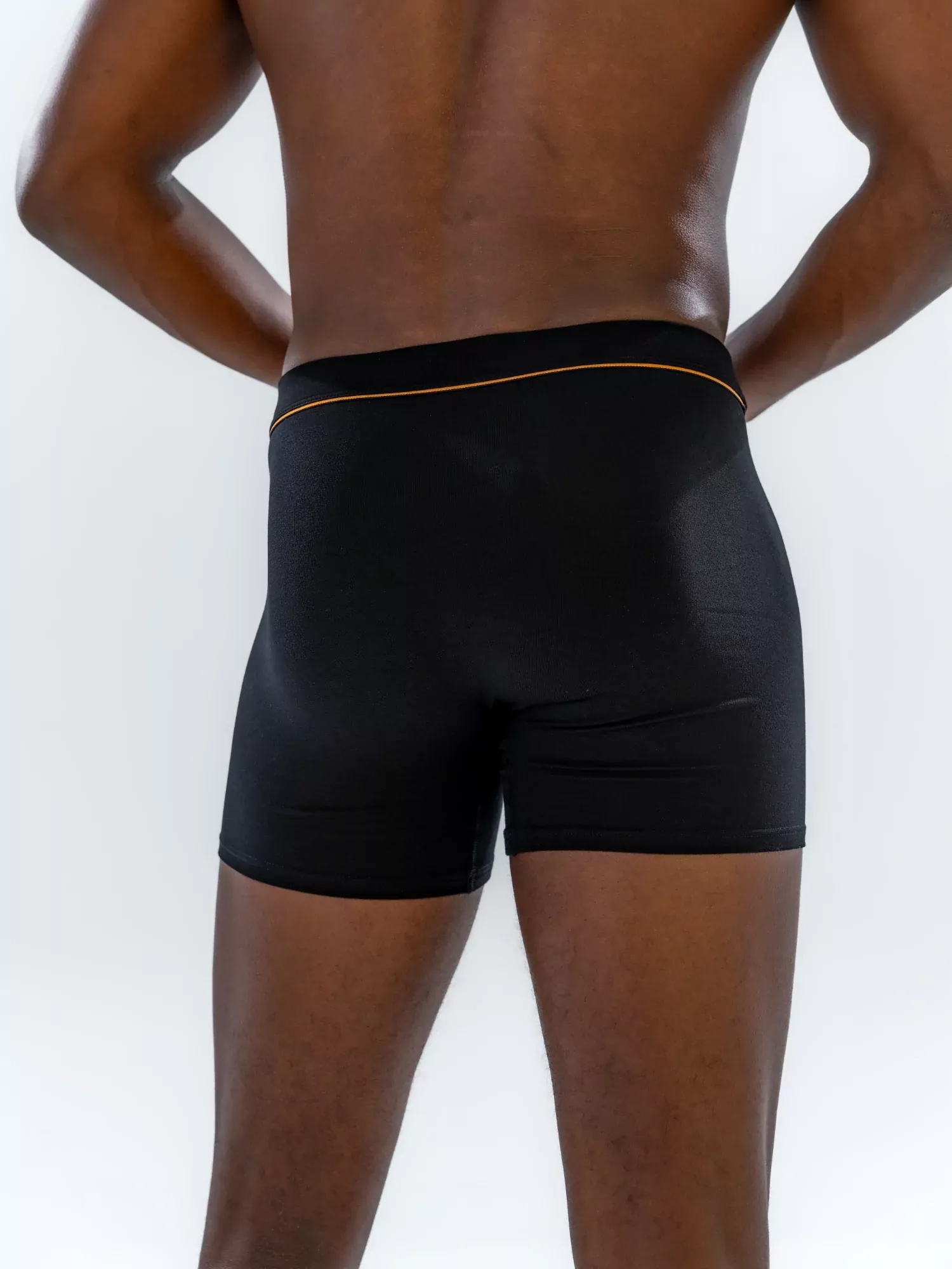 Close-up of the 4" Fabric-Wrapped Boxer Brief in black on a model, back view